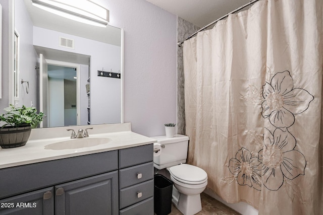 bathroom featuring curtained shower, toilet, and vanity