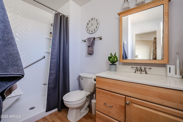 bathroom with hardwood / wood-style flooring, curtained shower, toilet, and vanity