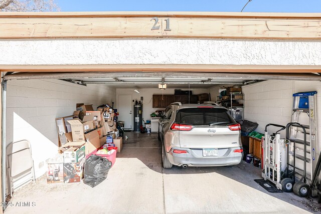 garage featuring water heater and a garage door opener