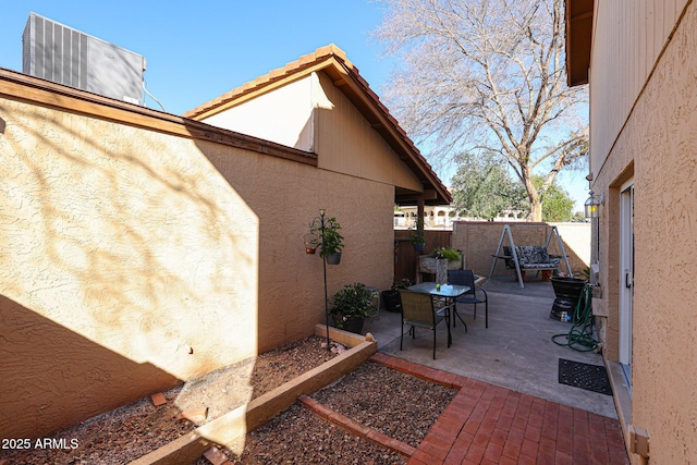 view of side of property with a patio area