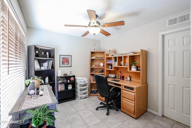 office space with ceiling fan and a textured ceiling