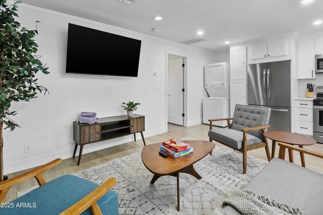 3139 N 40th St, Phoenix, AZ 85018 - living area with stacked washer and clothes dryer, recessed lighting, baseboards, and light wood finished floors