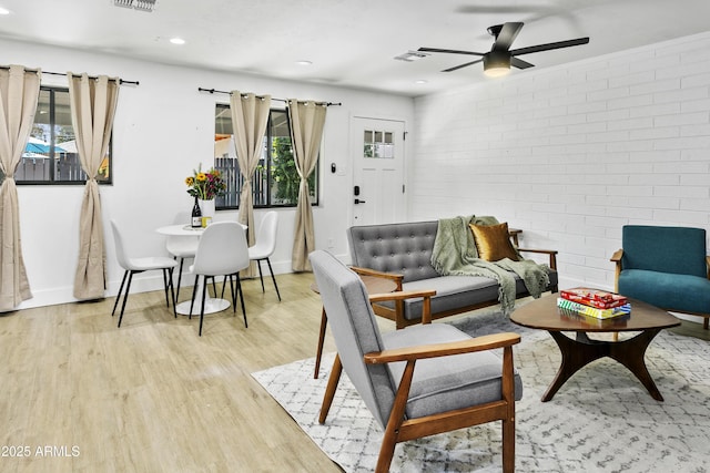 3139 N 40th St, Phoenix, AZ 85018 - living area featuring light wood-style flooring, a ceiling fan, brick wall, recessed lighting, and baseboards