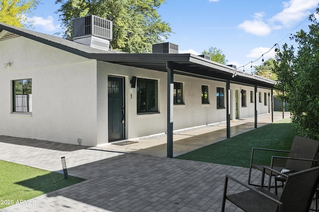 3139 N 40th St, Phoenix, AZ 85018 - back of property featuring central AC, a patio, and stucco siding