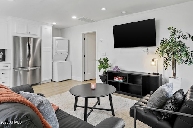 3139 N 40th St, Phoenix, AZ 85018 - living area featuring stacked washer / dryer, light wood-style floors, and recessed lighting