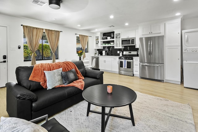 3139 N 40th St, Phoenix, AZ 85018 - living room with stacked washing machine and dryer, recessed lighting, light wood-type flooring, and a ceiling fan