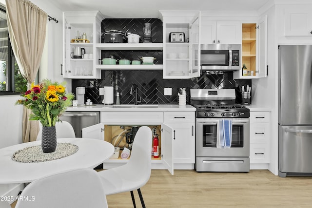 3139 N 40th St, Phoenix, AZ 85018 - kitchen with stainless steel appliances, open shelves, a sink, and light countertops