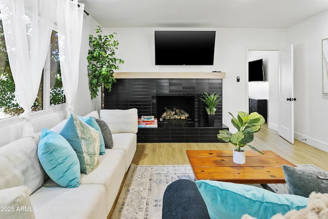 3139 N 40th St, Phoenix, AZ 85018 - living room with wood finished floors, a fireplace, and baseboards