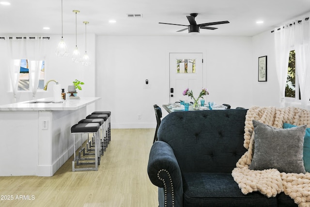 3139 N 40th St, Phoenix, AZ 85018 - living room with light wood finished floors, a ceiling fan, recessed lighting, and baseboards