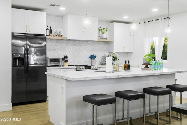 3139 N 40th St, Phoenix, AZ 85018 - kitchen featuring refrigerator with ice dispenser, tasteful backsplash, white cabinetry, light stone countertops, and recessed lighting