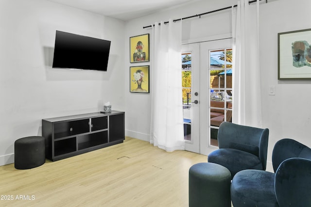 3139 N 40th St, Phoenix, AZ 85018 - living area with french doors, wood finished floors, and baseboards