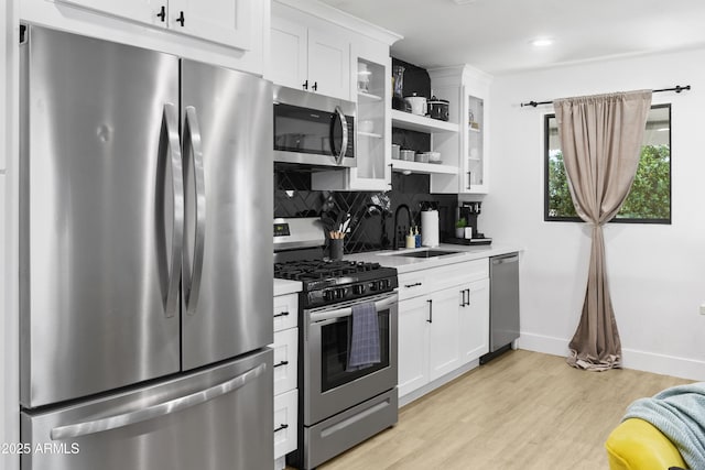 3139 N 40th St, Phoenix, AZ 85018 - kitchen featuring appliances with stainless steel finishes, a sink, baseboards, white cabinetry, and open shelves