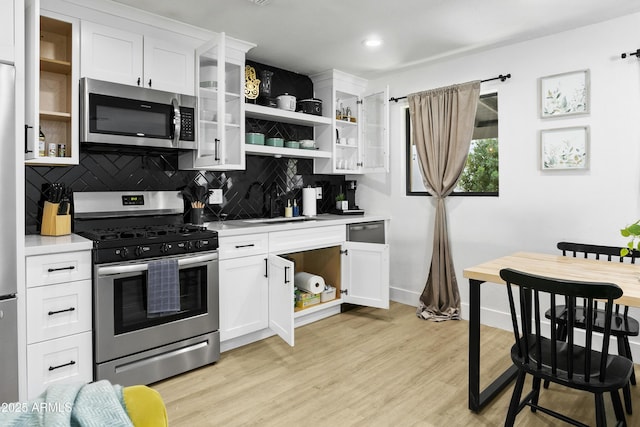 3139 N 40th St, Phoenix, AZ 85018 - kitchen featuring appliances with stainless steel finishes, open shelves, backsplash, light countertops, and recessed lighting