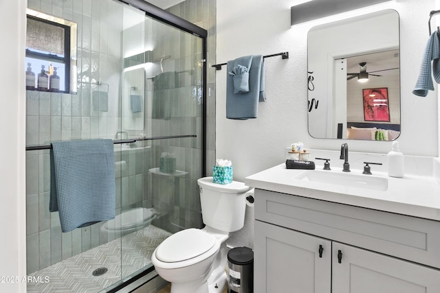 3139 N 40th St, Phoenix, AZ 85018 - full bathroom with toilet, vanity, ceiling fan, and a shower stall
