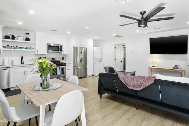 3139 N 40th St, Phoenix, AZ 85018 - dining room with stacked washer / dryer, light wood-style flooring, ceiling fan, and recessed lighting