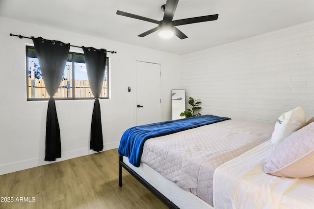 3139 N 40th St, Phoenix, AZ 85018 - bedroom with wood finished floors, baseboards, and ceiling fan