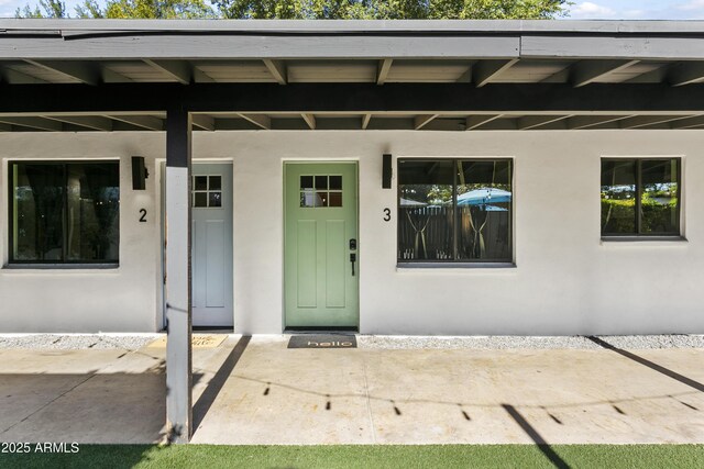 3139 N 40th St, Phoenix, AZ 85018 - view of exterior entry with stucco siding and a porch