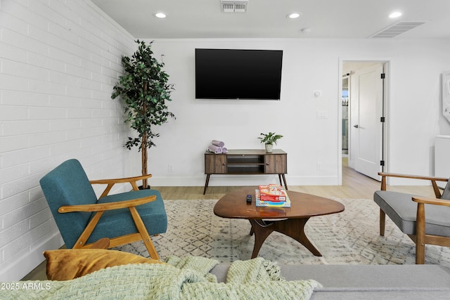 3139 N 40th St, Phoenix, AZ 85018 - living area featuring wood finished floors, recessed lighting, baseboards, and brick wall