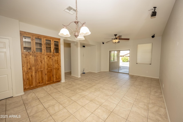 40808 N Raleigh Ct, Anthem, AZ 85086 - spare room featuring a chandelier, ceiling fan, baseboards, and light tile patterned floors