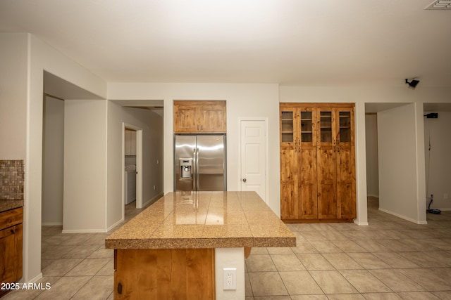 40808 N Raleigh Ct, Anthem, AZ 85086 - kitchen with stainless steel fridge, tile counters, light tile patterned flooring, and a center island