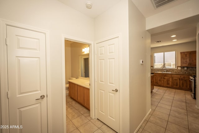 40808 N Raleigh Ct, Anthem, AZ 85086 - hallway with light tile patterned floors, a sink, and recessed lighting