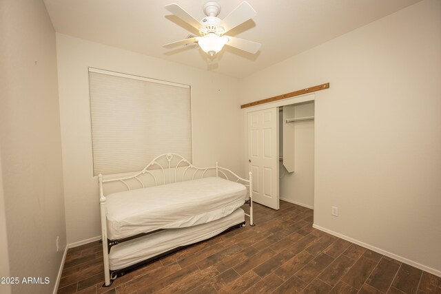40808 N Raleigh Ct, Anthem, AZ 85086 - bedroom with dark wood-style floors, baseboards, a closet, and a ceiling fan