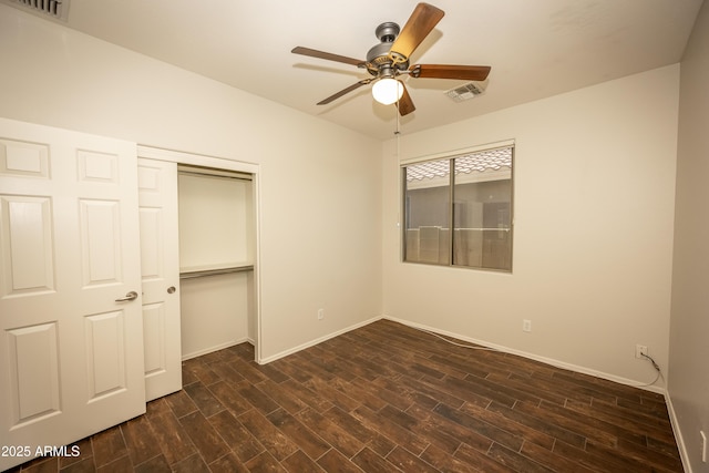 40808 N Raleigh Ct, Anthem, AZ 85086 - unfurnished bedroom featuring dark wood-type flooring, baseboards, a closet, and ceiling fan