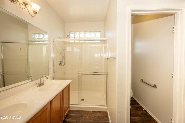 40808 N Raleigh Ct, Anthem, AZ 85086 - bathroom with a stall shower, double vanity, toilet, and wood finished floors
