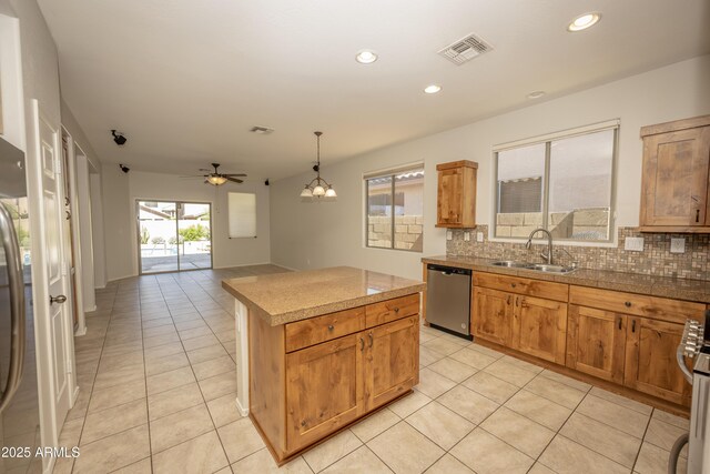 40808 N Raleigh Ct, Anthem, AZ 85086 - kitchen with a sink, decorative backsplash, light tile patterned floors, dishwasher, and a kitchen island