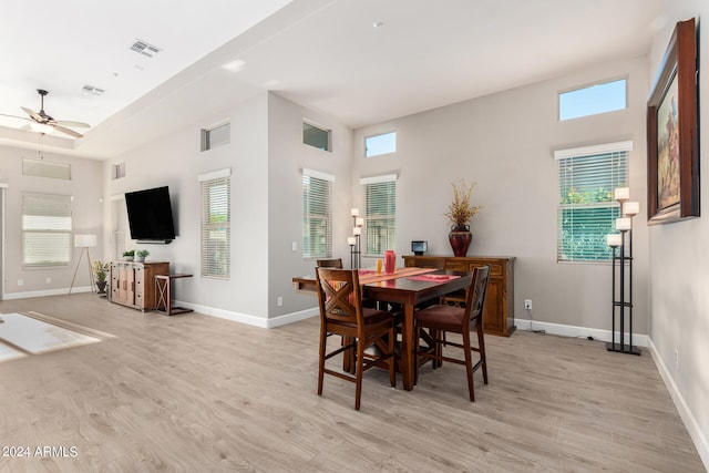 dining space with ceiling fan and light hardwood / wood-style floors