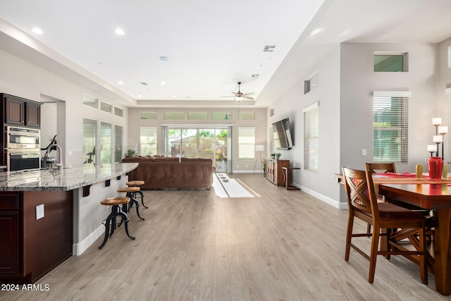 interior space featuring light wood-type flooring, ceiling fan, and a wealth of natural light