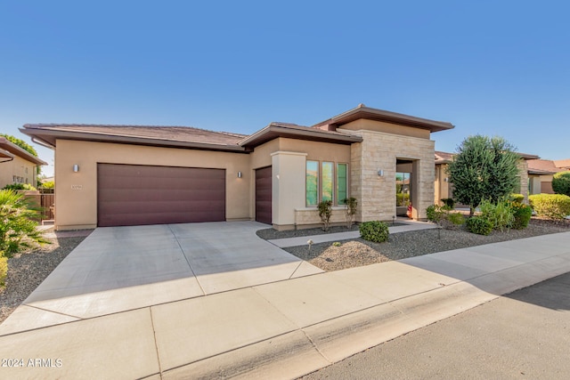 prairie-style home featuring a garage