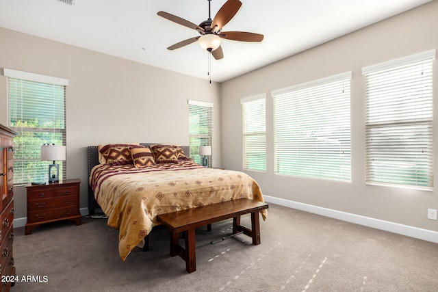 bedroom featuring dark colored carpet and ceiling fan