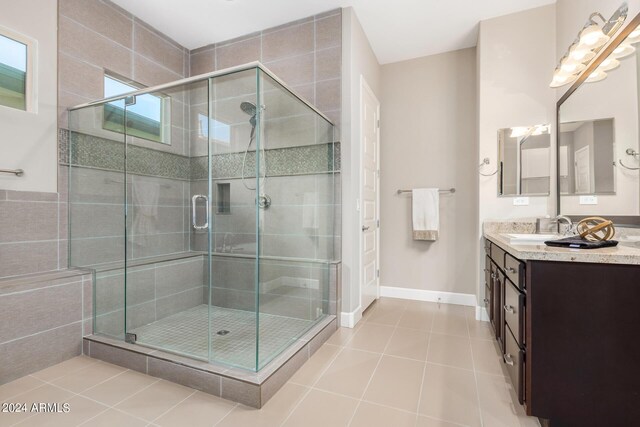 bathroom featuring vanity, tile walls, an enclosed shower, and tile patterned floors