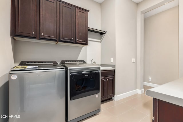 laundry room featuring cabinets, sink, independent washer and dryer, and light tile patterned flooring