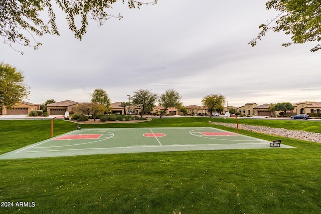 view of basketball court with a yard