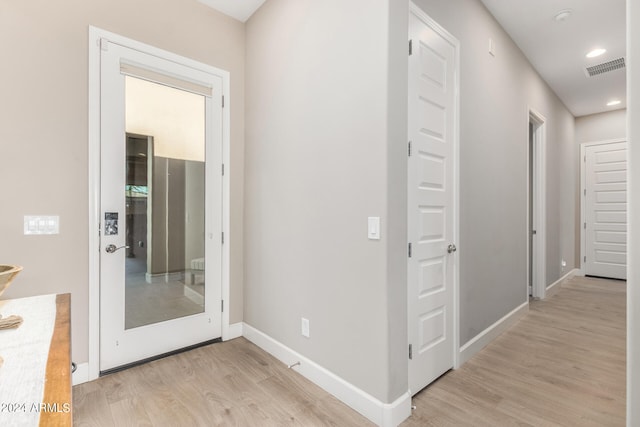 corridor with light hardwood / wood-style flooring