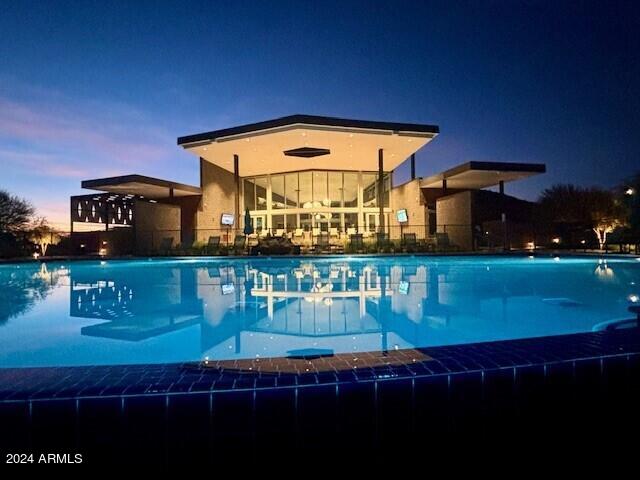 view of pool at dusk