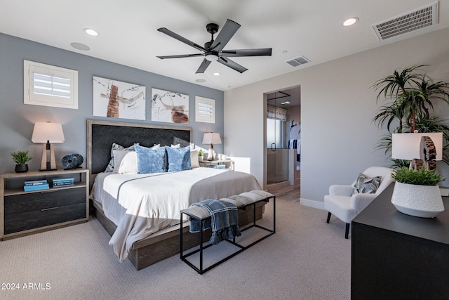 carpeted bedroom featuring ceiling fan and multiple windows