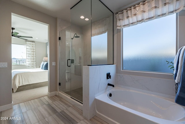 bathroom featuring ceiling fan and shower with separate bathtub