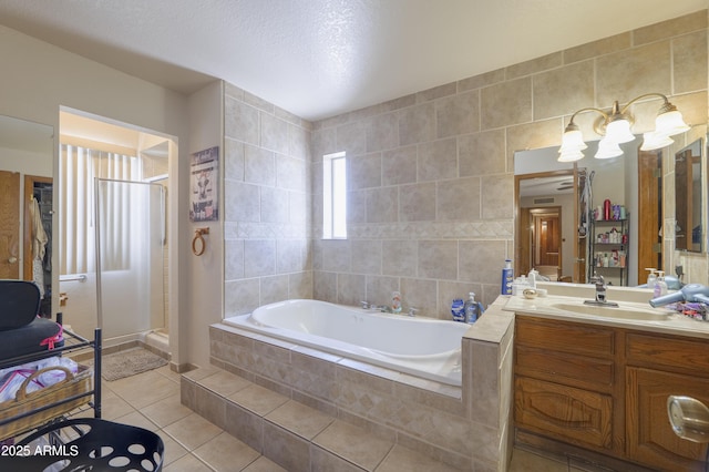 1285 E Mcmurray Blvd, Casa Grande, AZ 85122 - full bath featuring tile patterned floors, a garden tub, vanity, a shower stall, and tile walls
