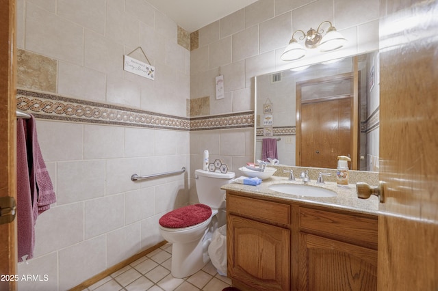 1285 E Mcmurray Blvd, Casa Grande, AZ 85122 - half bathroom with tile walls, vanity, tile patterned floors, and toilet