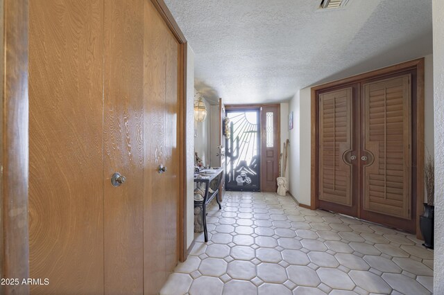 1285 E Mcmurray Blvd, Casa Grande, AZ 85122 - entryway featuring a textured ceiling, baseboards, and light flooring