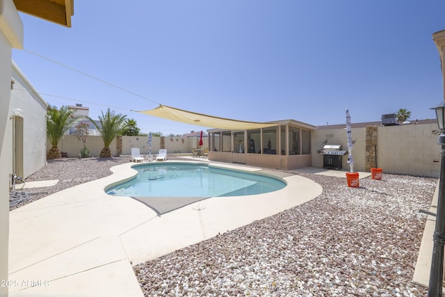1285 E Mcmurray Blvd, Casa Grande, AZ 85122 - view of swimming pool featuring a sunroom, a patio area, a fenced backyard, and a grill