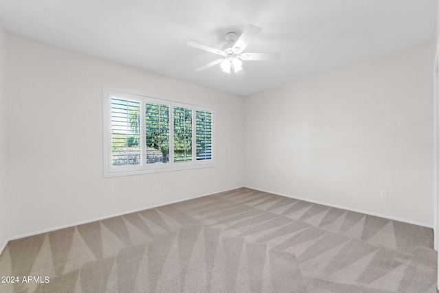 spare room featuring carpet and ceiling fan