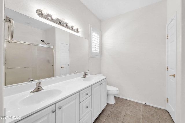 bathroom featuring vanity, tile patterned floors, a shower with shower door, and toilet