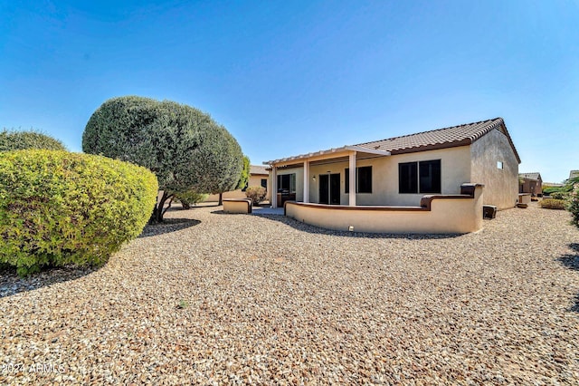 back of property featuring a patio