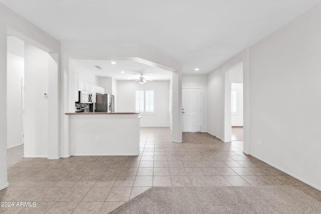 interior space featuring ceiling fan and light tile patterned floors