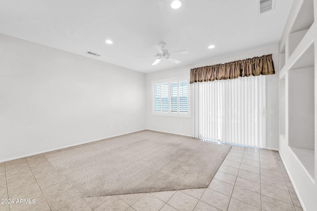 spare room featuring ceiling fan and light tile patterned flooring