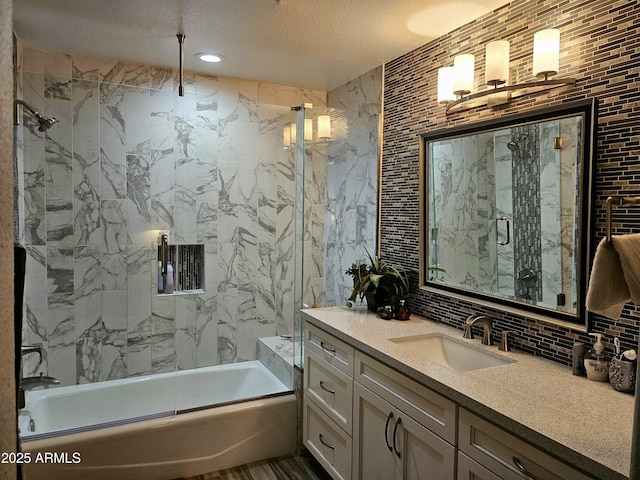 bathroom featuring decorative backsplash, vanity, tile walls, and combined bath / shower with glass door